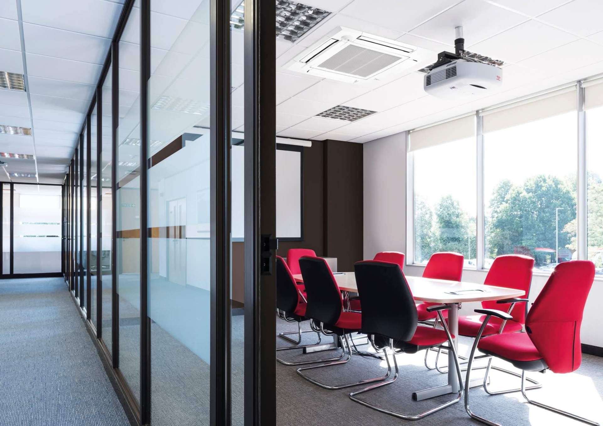 Wall-mounted air conditioning unit installed above doorway in a residential bedroom
