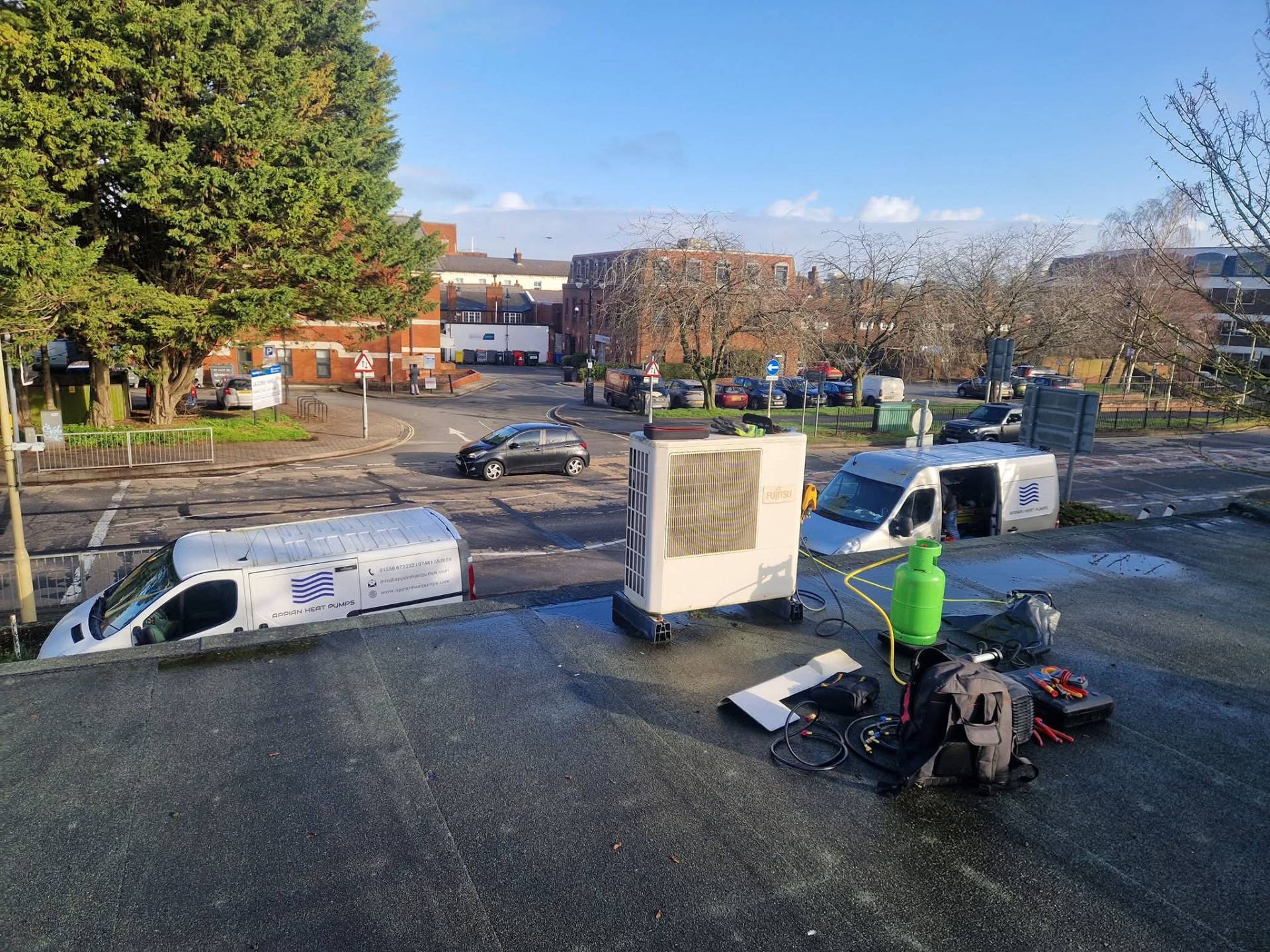 New heat pump hot water cylinder installed in utility cupboard with pipework connections
