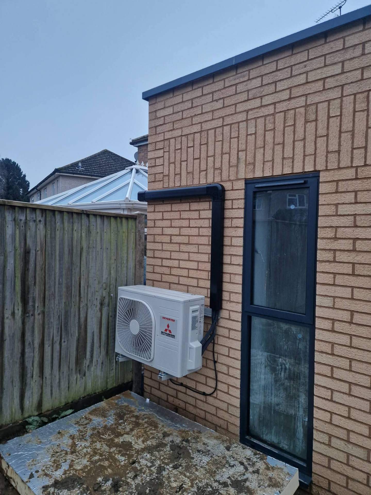 Refrigerant manifold gauges connected during heat pump commissioning and pressure testing