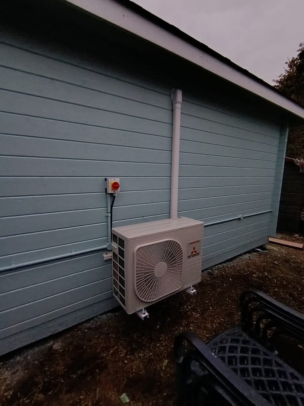 Multiple air conditioning condensers installed outside commercial premises in Surrey