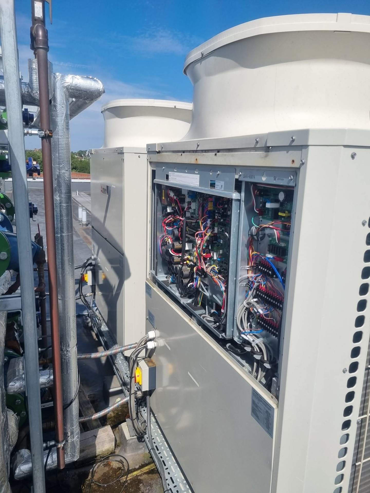 Heat pump servicing — cleaning evaporator coil fins on outdoor unit in Hampshire