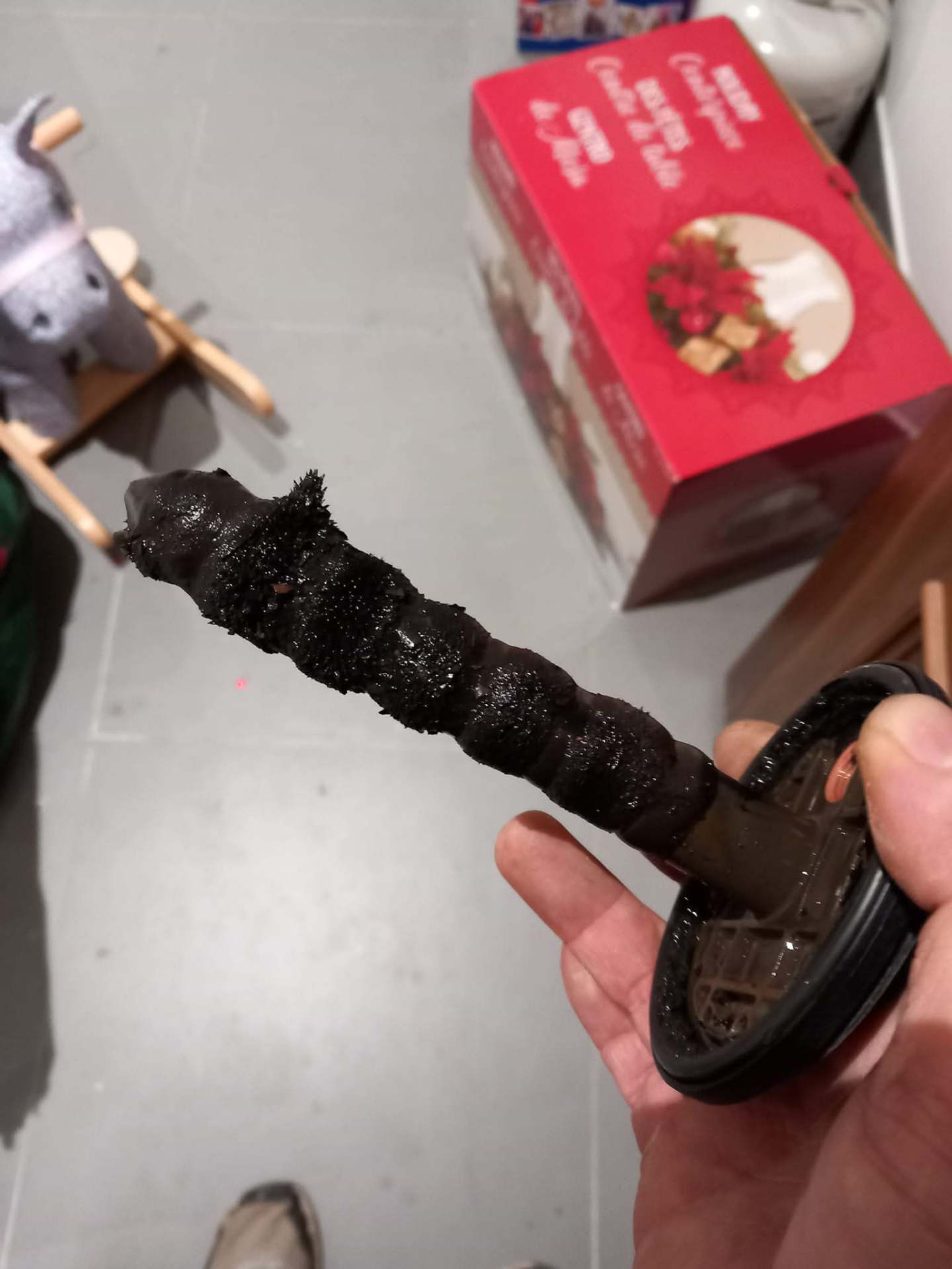 Magnetic filter removed during heat pump servicing showing heavy magnetite sludge buildup from central heating system